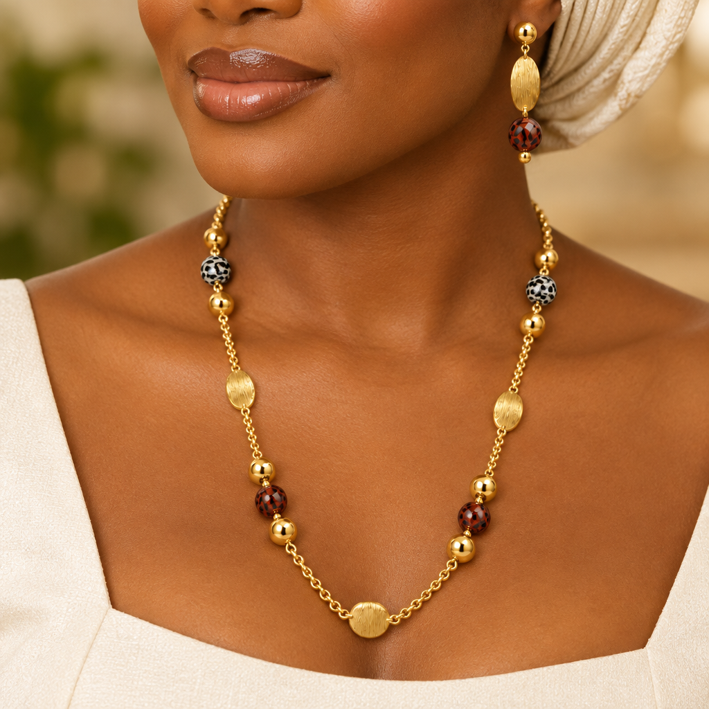 Woman wearing gold leopard bead necklace and drop earrings