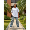 Nigerian female model wearing white Living My Best Life graphic tee – front view