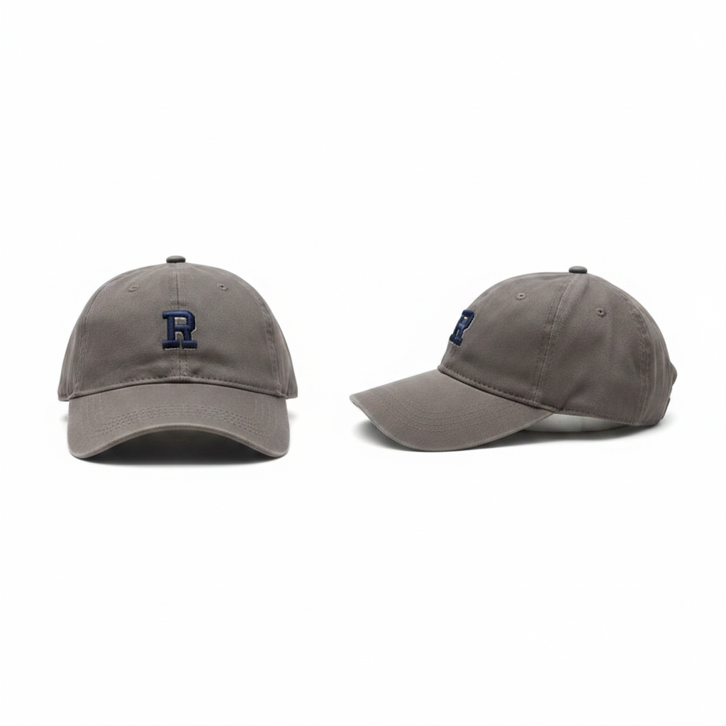 Muted grey dad cap with navy blue block letter R embroidery – ghost mannequin front and side view
