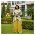 Nigerian female model wearing green leaf print top and mustard yellow pleated palazzo trousers set