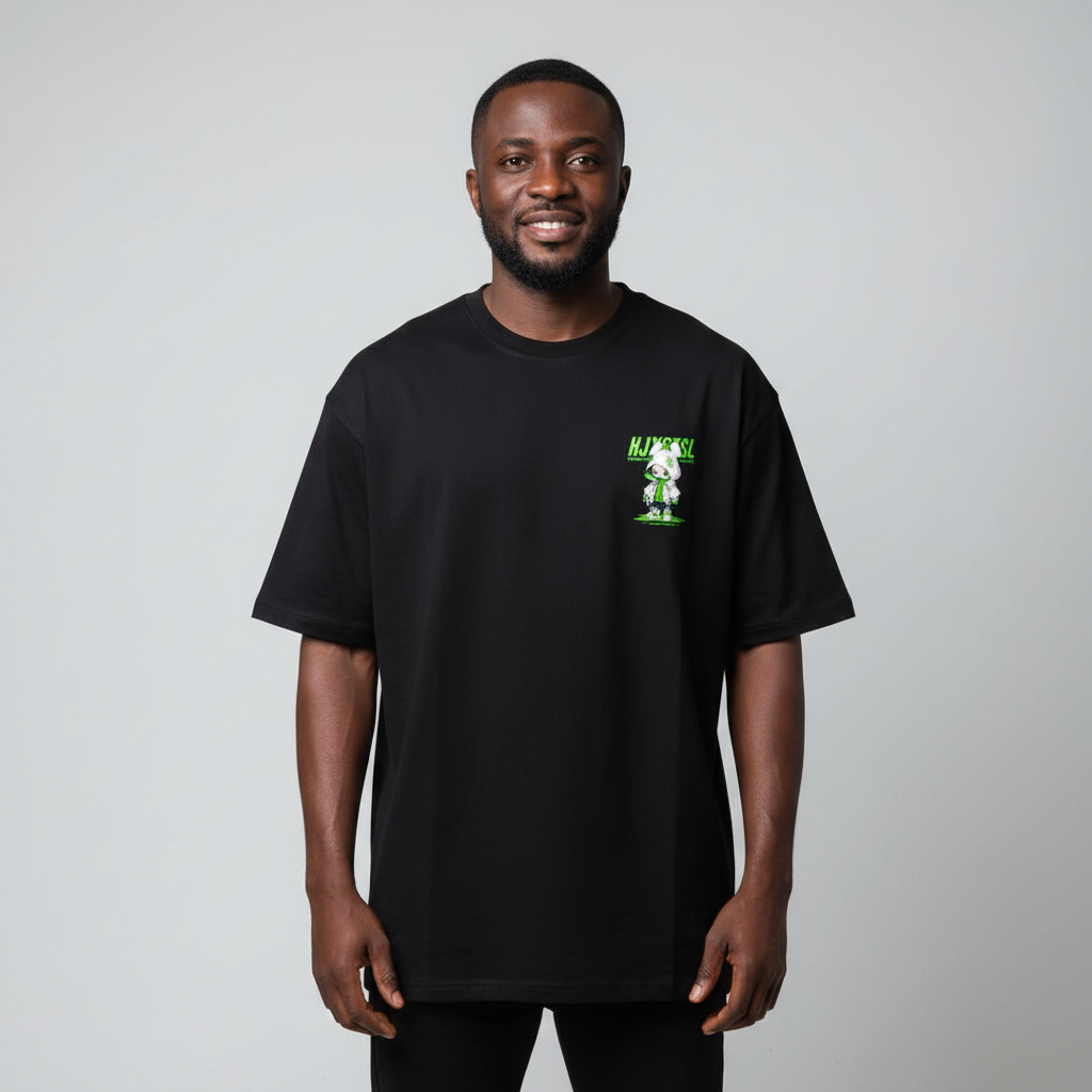 Model wearing black green cartoon graphic tee