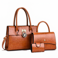Brown three-piece set with two top-handle handbags and a snap wallet on a white background