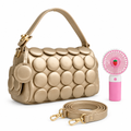 Champagne-gold circle-appliqué shoulder bag with matching strap and pink handheld fan on white background