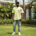 Nigerian male model wearing lime yellow multicolour tie-dye splatter graphic tee – front view