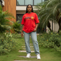 Nigerian female model wearing red explore outdoors graphic oversized tee – front view