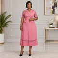 Adult Black woman wearing a pink floral-detail pleated dress