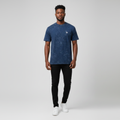 Young Nigerian male wearing acid wash navy marble texture crew neck tee with silver logo