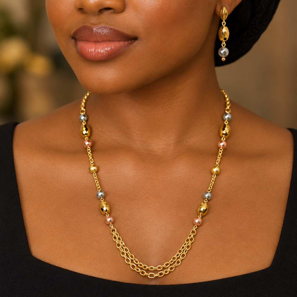 Woman wearing tri-tone gold bead layered necklace and earrings
