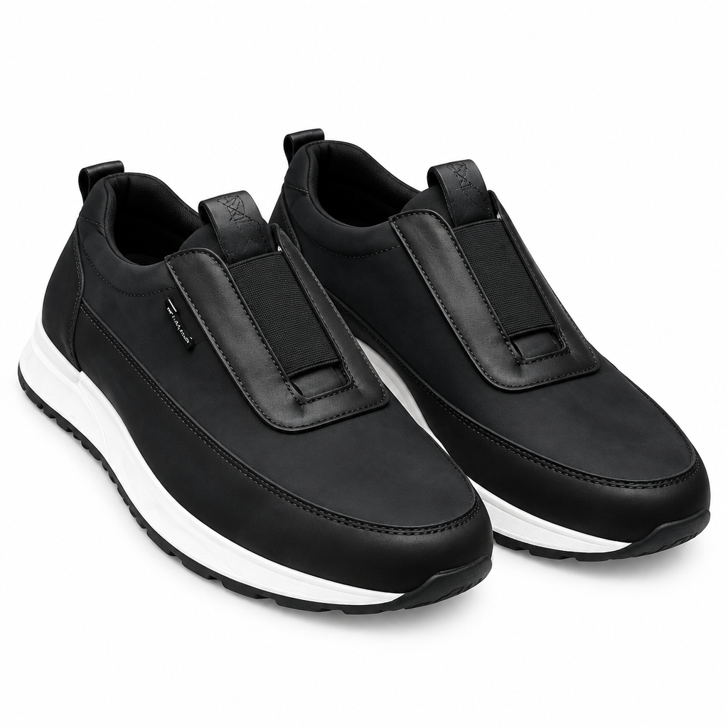 Pair of black panelled slip-on shoes on white