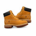Pair of wheat-tan lace-up boots with black padded collars on white