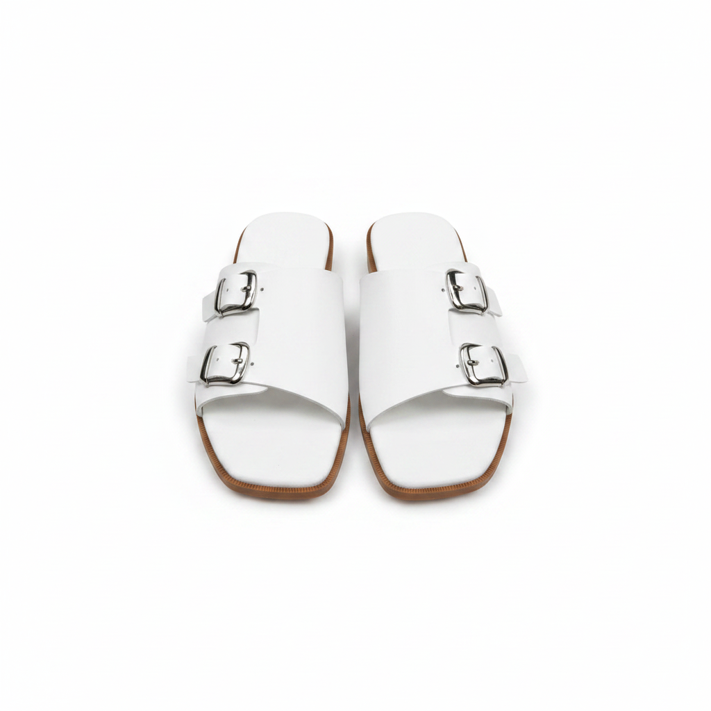 Pair of white leather double buckle flat slide slippers on white background