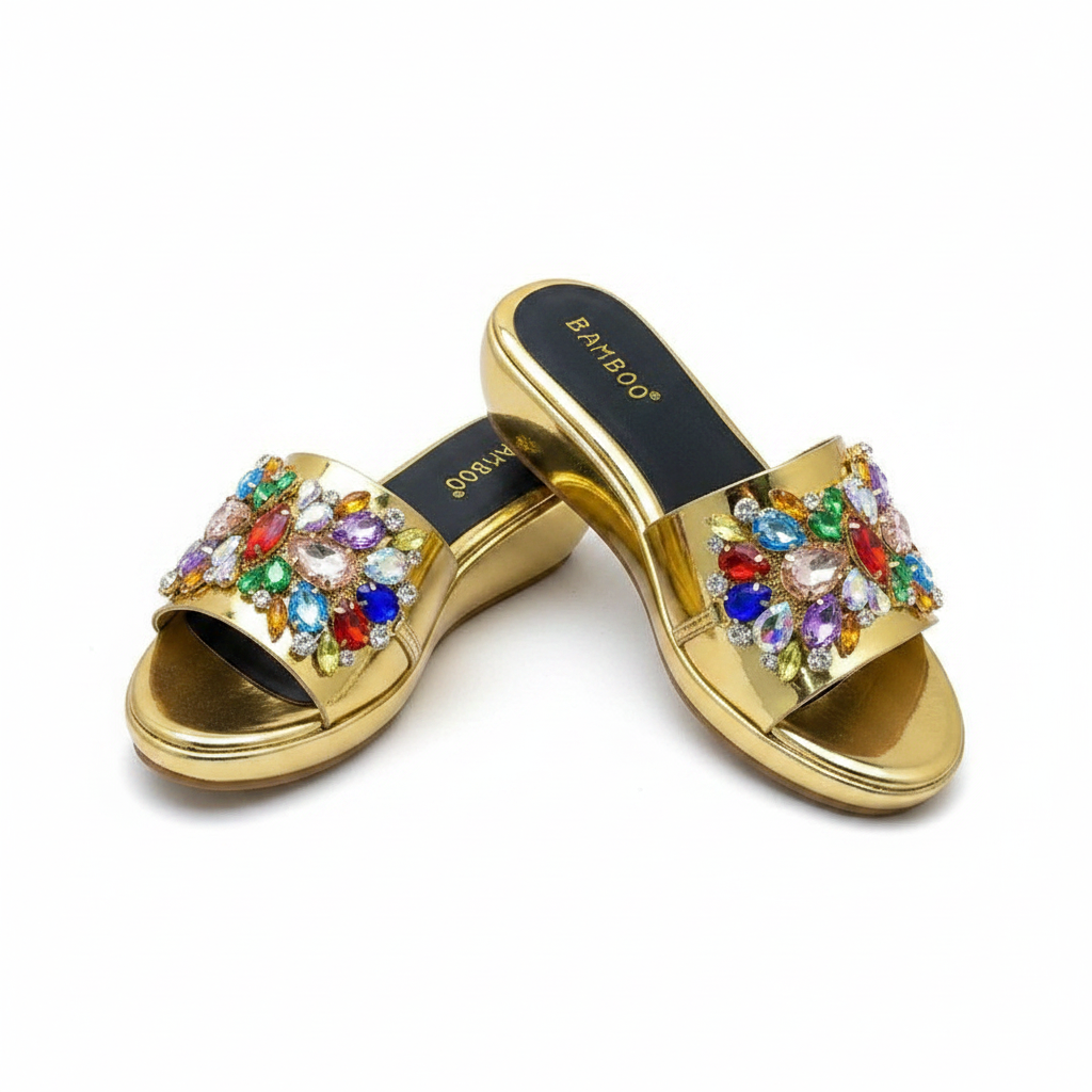 Ghost mannequin pair view of gold metallic wedge slide mules with multicolour gemstone rhinestone floral strap