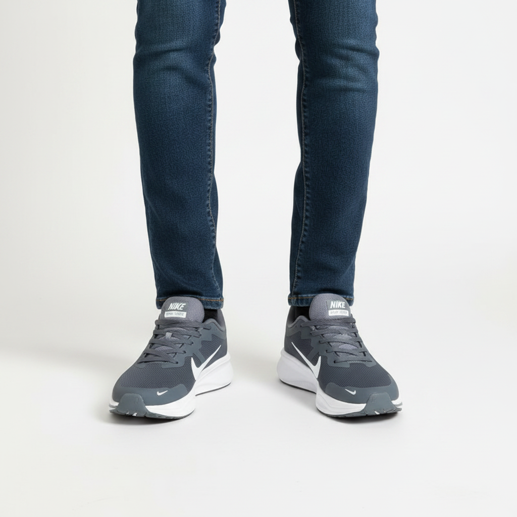 Ash grey mesh sneakers with white sole worn with dark jeans