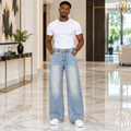 Man wearing light wash wide-leg hook-clasp jeans with white tee