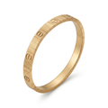 Gold-tone ribbed screw-detail bracelet isolated on plain white