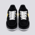 Black suede low-top sneakers with yellow side logo, front view