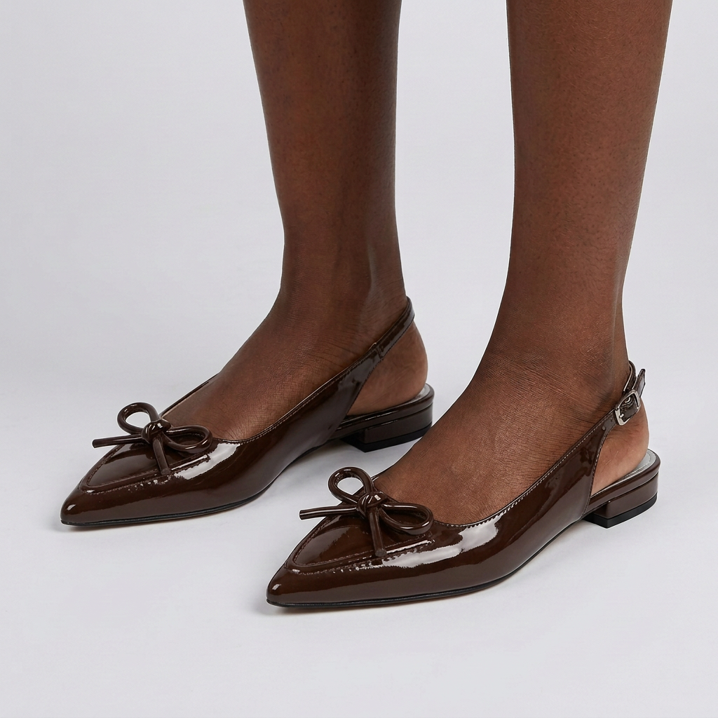 Both feet wearing coffee-brown bow slingbacks on plain studio background