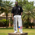 Nigerian male model wearing white graphic print wide-leg sweatpants – full body lifestyle shot