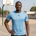 Black Nigerian male model wearing blue premium sport jersey on basketball court