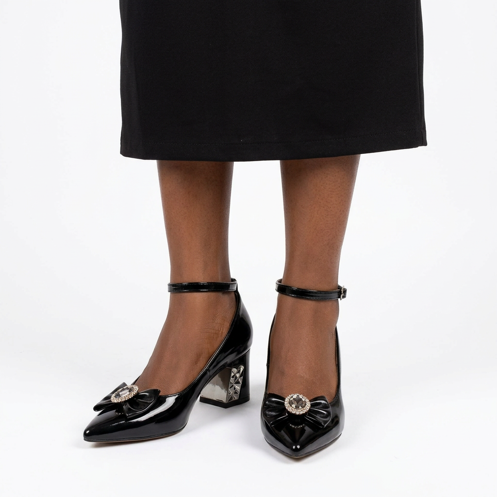 Adult woman with feet close together wearing black jeweled-bow ankle-strap block heels