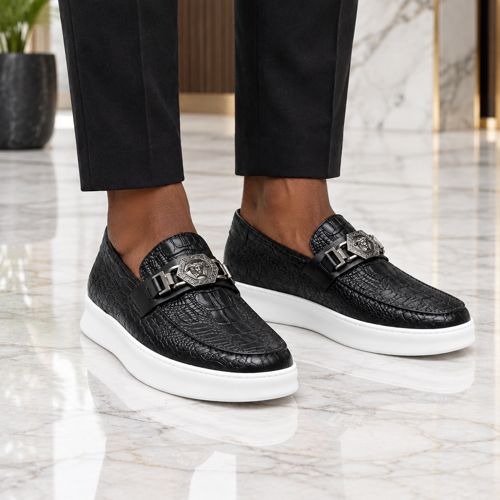 Man wearing black croc-embossed medallion loafer sneakers
