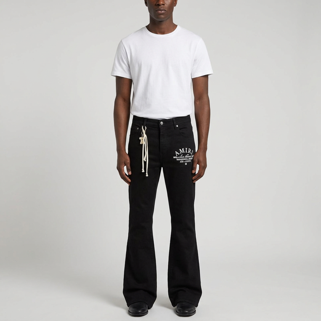 Man wearing black graphic flared trousers on plain studio background