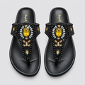 Pair of black beaded thong sandals with yellow stone details