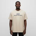 Black Nigerian male model wearing a beige classic graphic T-shirt