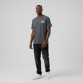 Young Nigerian male wearing charcoal grey Snoop Dogg gothic graphic tee