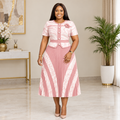 Adult Black woman wearing blush pink patterned pleated dress