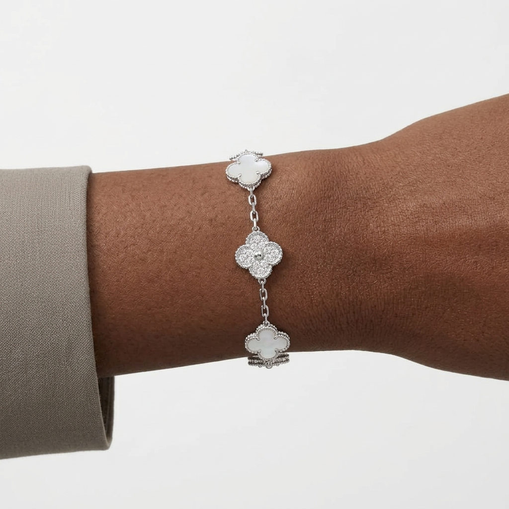 Silver-tone white and stone-accent clover bracelet on a Black adult wrist