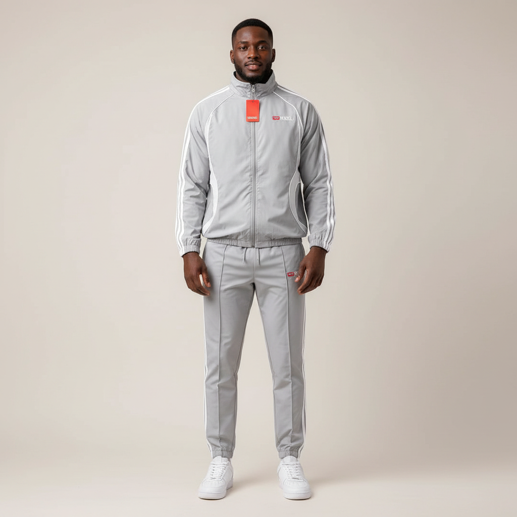 Model wearing the grey and white two-piece tracksuit