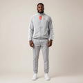 Model wearing the grey and white two-piece tracksuit
