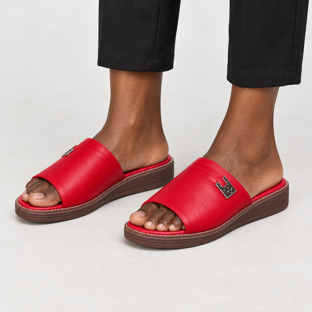 Red slide sandals worn on both feet