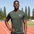 Black Nigerian male model wearing dark olive premium sport jersey on running track