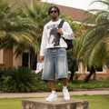 Nigerian male model wearing men's light blue tribal flame embroidered hardware denim shorts streetwear style