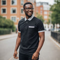 STEEZU black short-sleeve polo shirt with silver-grey tipping on collar and sleeves, and a faux pocket detail.