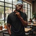 STEEZU Super Premium black structured polo shirt with open collar, diagonal seam detailing, and short sleeves. Oversized unisex fit.