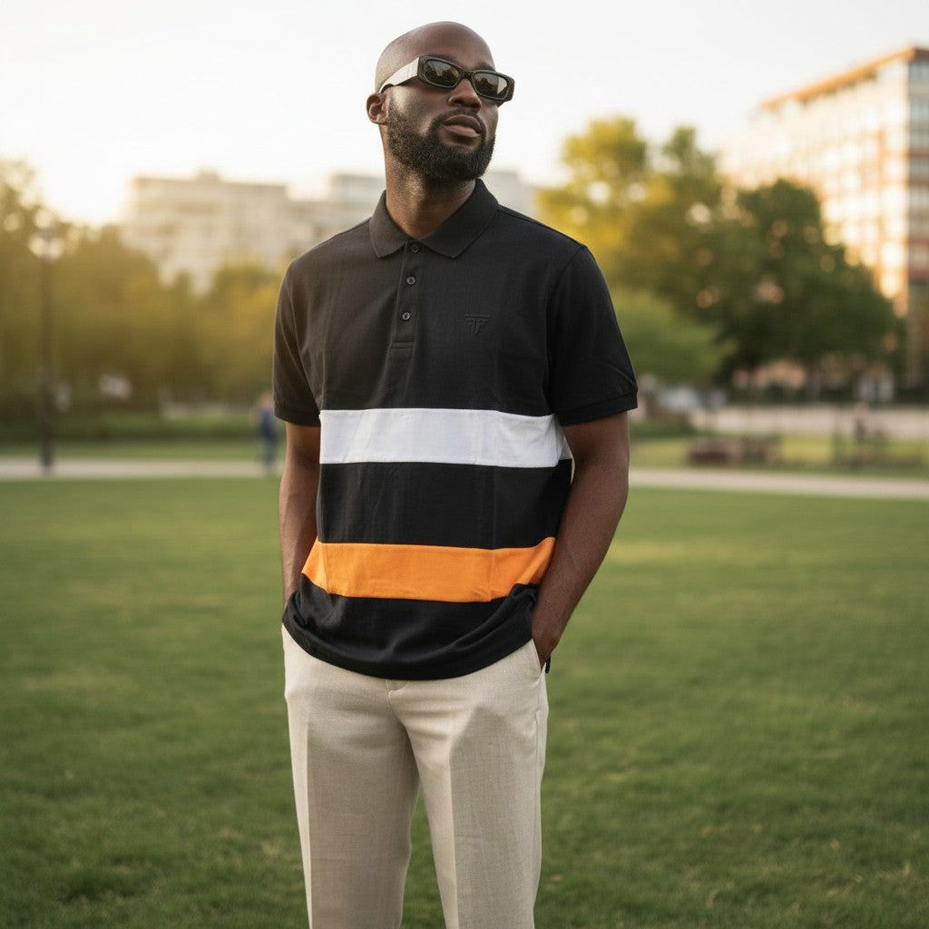 STEEZU black polo shirt with white and solar orange horizontal panels, short sleeves, and a classic collar.