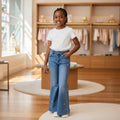 STEEZU Girls' medium wash denim flare jeans with scattered rhinestones and star studs. Designed for ages 4-10.