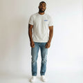 STEEZU RAYZ Phenomenon white oversized graphic t-shirt with blue logo detail worn by a man with blue jeans