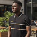 STEEZU Umbro black polo shirt with gold and white chest stripes, gold logo, and striped collar and cuffs.