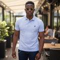 STEEZU white pique cotton short-sleeve polo shirt with navy embroidered polo pony logo and classic collar.