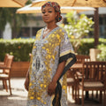 STEEZU yellow maxi kaftan dress with black, white, and yellow paisley print, V-neckline, and flowing silhouette.